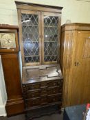 1920's oak bureau bookcase having two leaded glass doors above a fall front with three drawers
