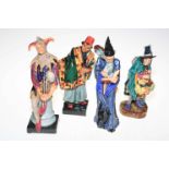 Four Royal Doulton figures, The Mask Seller, Carpet Seller, The Jester and The Wizard.