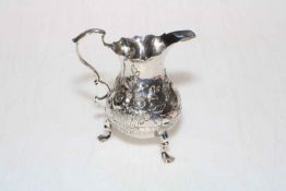 George III silver cream jug embossed with flowers, fruit and cartouche, London 1767 (3).