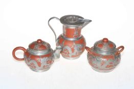 Chinese Yixing Earthen Ware tea set with silvered design overlay.