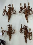 Two pairs of ornate gilt metal wall lights.