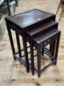 Nest of three Oriental hardwood tables (largest 60cm by 42.5cm by 31.5cm).