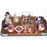 Seven Royal Crown Derby Imari pattern paperweights, two lidded boxes and cup.