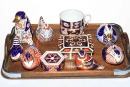 Seven Royal Crown Derby Imari pattern paperweights, two lidded boxes and cup.