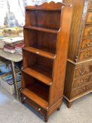 Multiyork cherrywood waterfall bookcase with base drawer, 151cm by 57cm by 36cm.