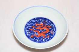 Chinese porcelain blue and white saucer dish decorated with internal red dragon,