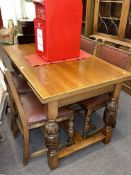 Rectangular oak draw leaf dining table and four studded hide dining chairs.