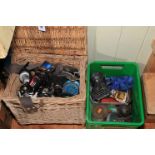 Wicker fishing basket containing various reels, American Honey boxes, etc.