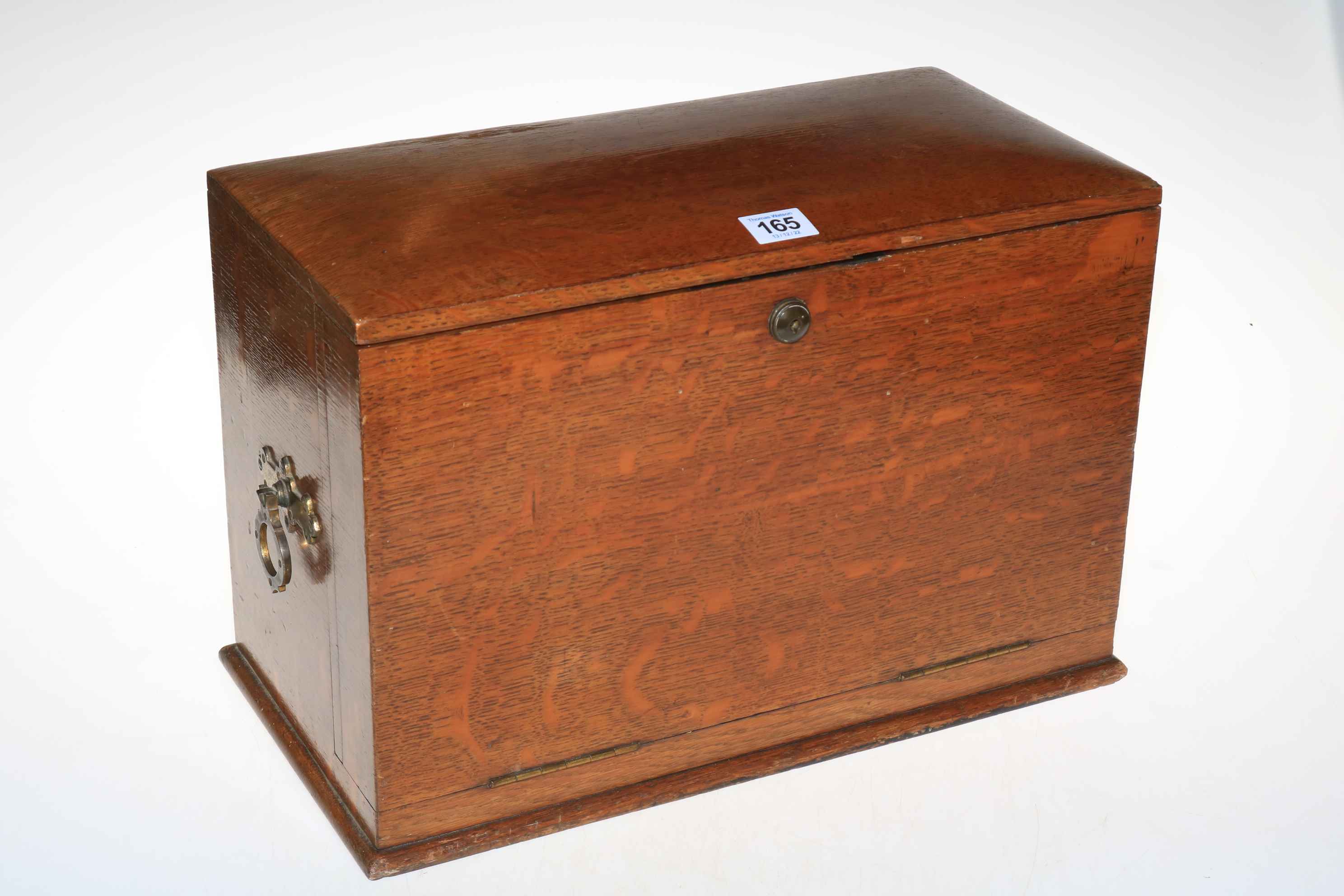 An early 20th Century oak fall front stationery cabinet, 28cm high.