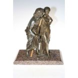 Ornate cast metal figure of a couple on marble base.