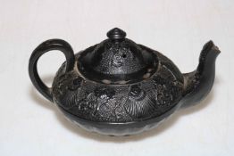 Chinese Yixing teapot with lid decorated with fan design and flowers.