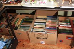 Nine boxes of assorted books.