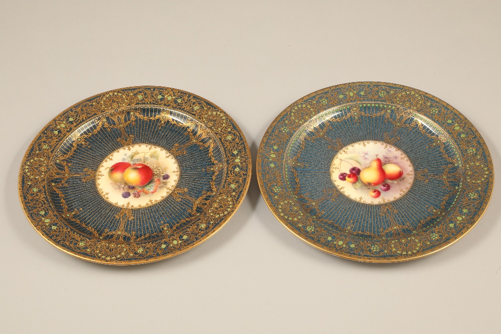 Pair Royal Worcester cabinet plates, blue ground with central hand painted panels of fruit signed