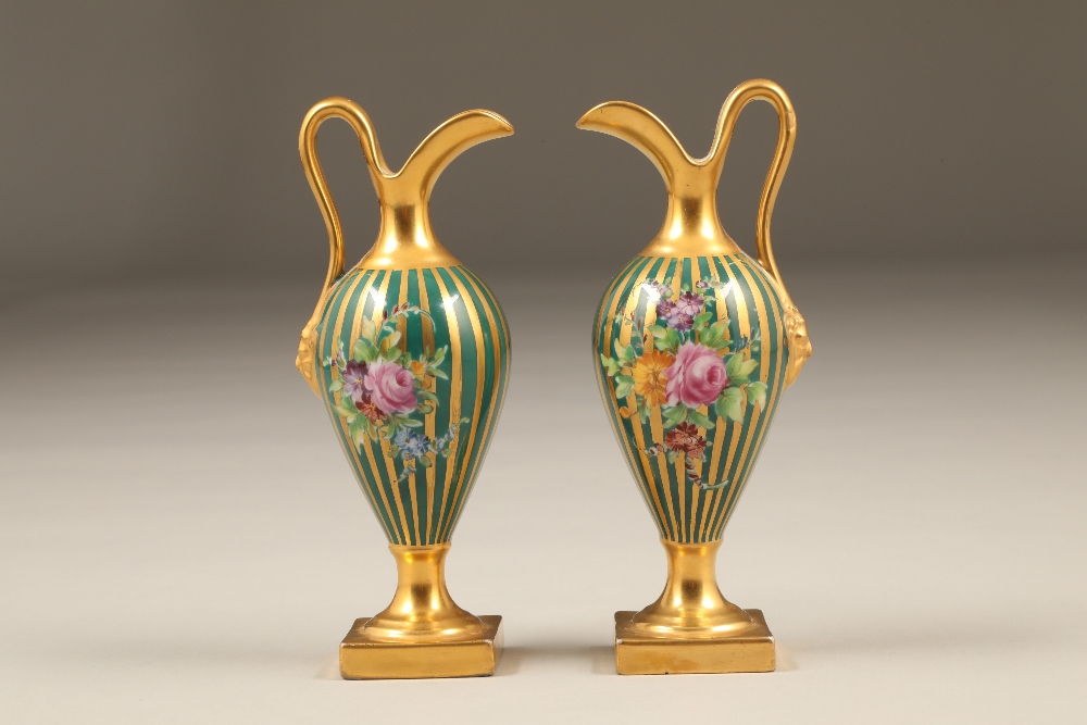 Pair of late 19th / early 20th century probably Dresden porcelain ewers, with richly gilded and