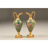 Pair of late 19th / early 20th century probably Dresden porcelain ewers, with richly gilded and