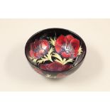 Moorcroft pottery bowl, dark blue ground, decorated with the anemone pattern Diameter 16cm, height