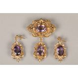 Victorian 9 carat gold and amethyst brooch, and a pair of matching earrings, oval cut amethysts