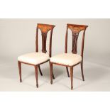 Pair of Edwardian inlaid rosewood side chairs, top rails with inlaid swags and tails, stuff over