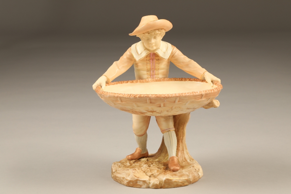 Royal Worcester figure, boy holding a large basket, signed Hadley, date coded 1886 Height 23cm