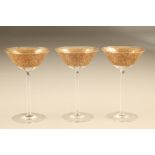 Set of nine gilt overlaid drinking glasses by Johan Oertel, raised on plain stem terminating in a