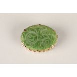 9 carat gold mounted carved jade brooch, oval form, with carved floral decoration, maker SEC