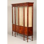 Edwardian flame mahogany display cabinet, moulded dental cornice over serpentine front. Two thirds