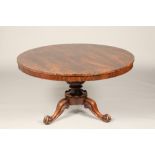 Victorian rosewood tip up breakfast table, circular top on carved central column, on tripod feet