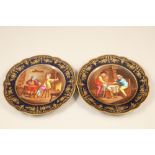 Pair Serves cabinet plates, dark blue ground with hand painted interior scenes with figures,