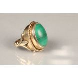 Unmarked yellow metal ring, set with an oval malachite cabochon Total weight 14g, ring size K/L