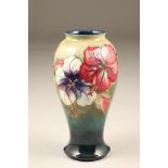 Moorcroft pottery vase, slender baluster form, decorated with hibiscus pattern, original paper