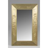 Arts and Crafts brass framed mirror, embossed stylised leaves and fuchsias decoration Height 74cm,