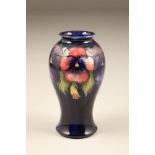 Moorcroft pottery vase, baluster form, dark blue ground, decorated with pansy pattern height 18cm