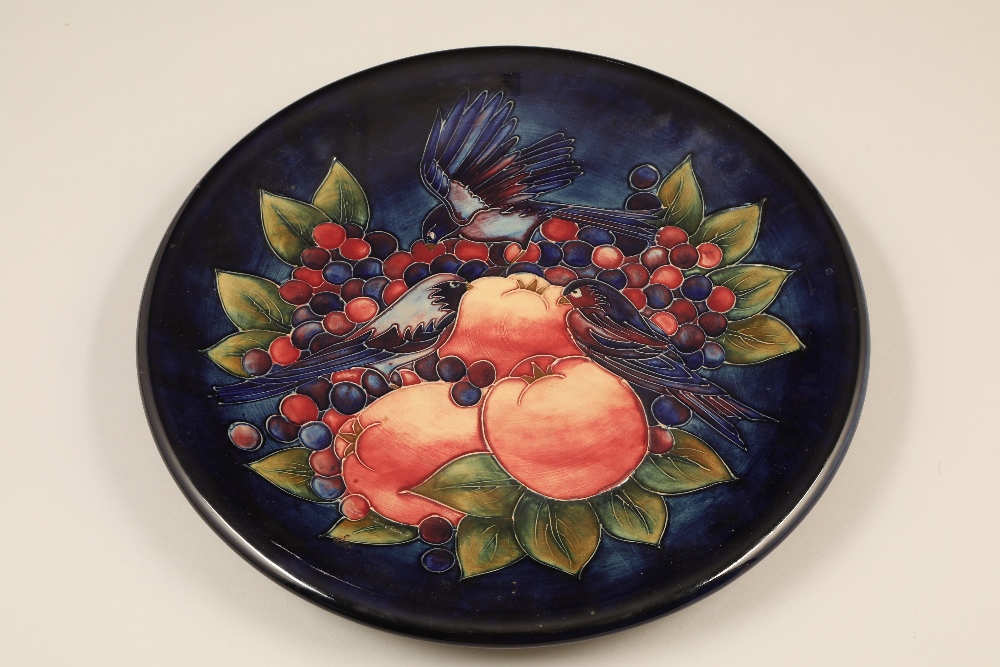 Moorcroft pottery charger, dark blue ground, decorated with finches, Diameter 35.5cm