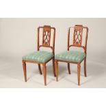 Pair of Edwardian inlaid mahogany side chairs, crossbanded back slats, stuff over seats raised on