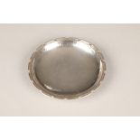 George VI hallmarked silver planished silver circular dish, Omar Ramsden, London 1938, with shaped