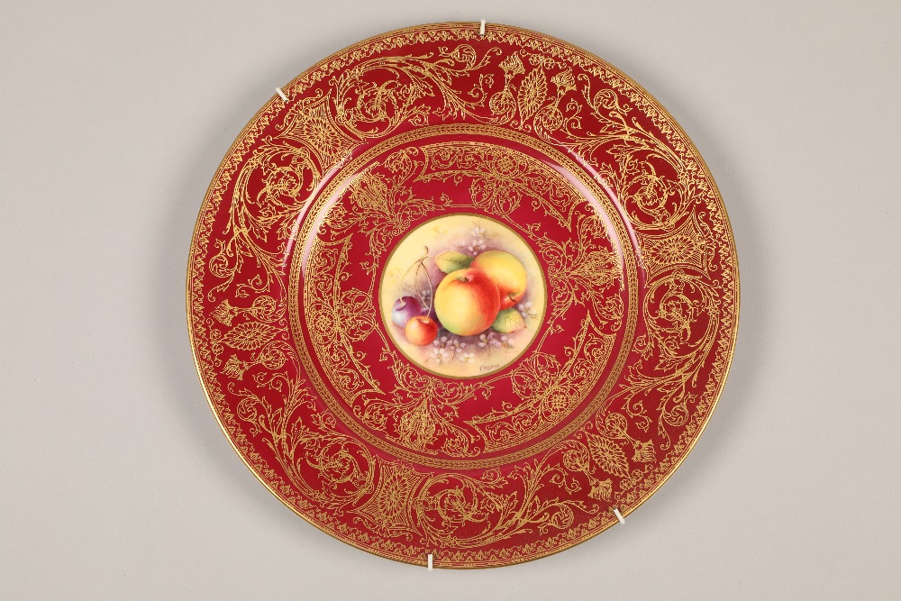 Royal Worcester cabinet plate, painted with a central panel of fallen fruit within a red ground with