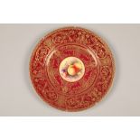 Royal Worcester cabinet plate, painted with a central panel of fallen fruit within a red ground with