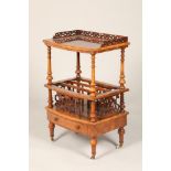 Victorian walnut canterbury, ornate fretwork gallery, supported on turned columns with a