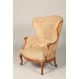 Continental 19th century walnut lounge chair, with carved apron on cabriole legs, upholstered in