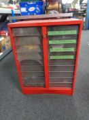 A metal framed mechanics chest containing eighteen plastic drawers