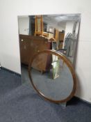 A large bevelled mirrored glass panel and a circular framed mirror