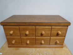 An oak table top eight drawer index chest
