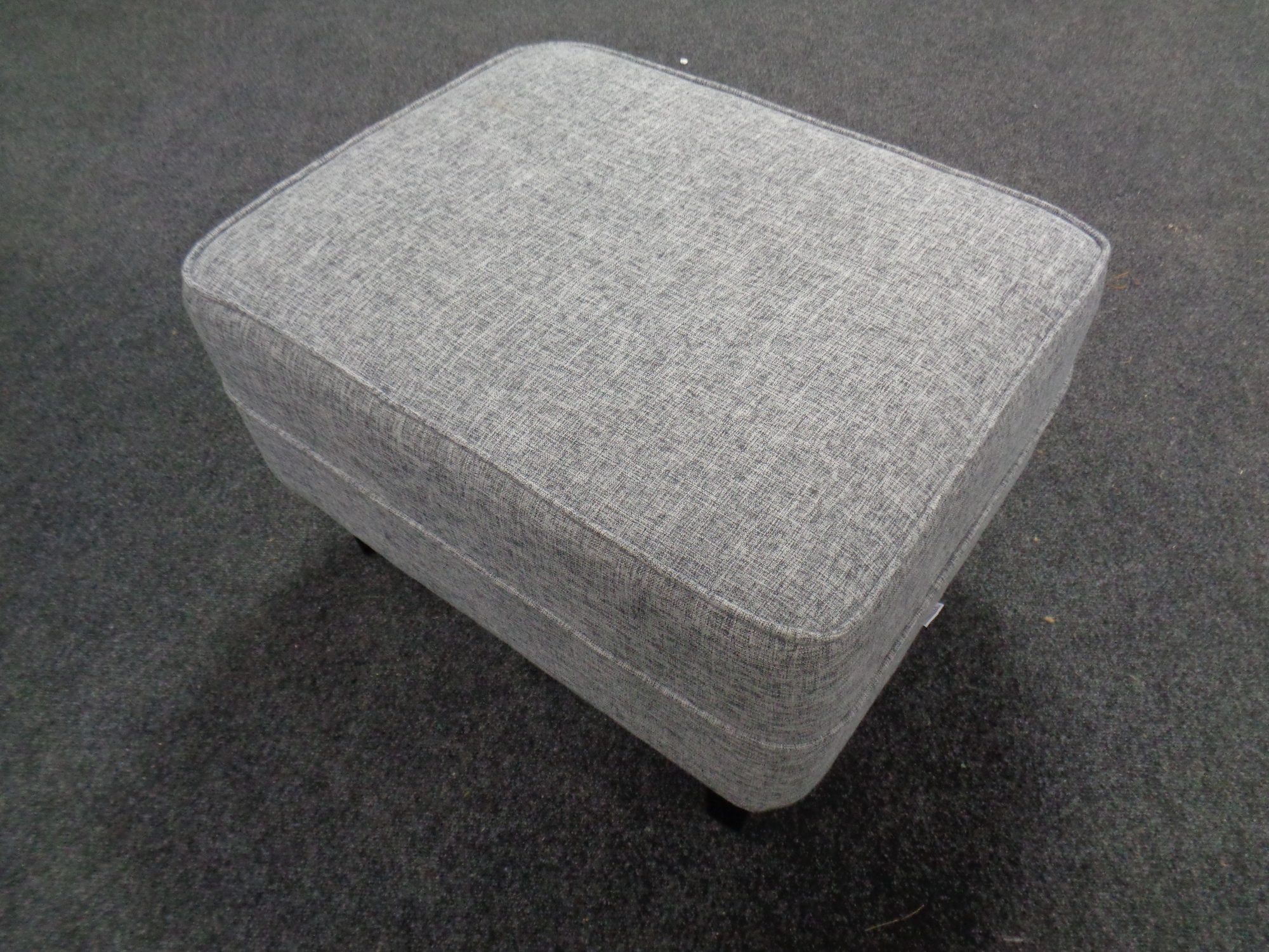 A contemporary Lifelook footstool upholstered in a grey fabric