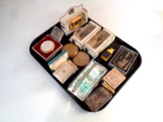 A tray containing a collection of lady's compacts, cigarette case containing Maltese note,