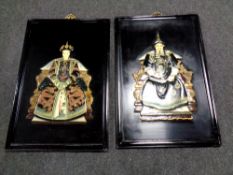 A pair of Japanese black lacquered relief panels depicting emperors