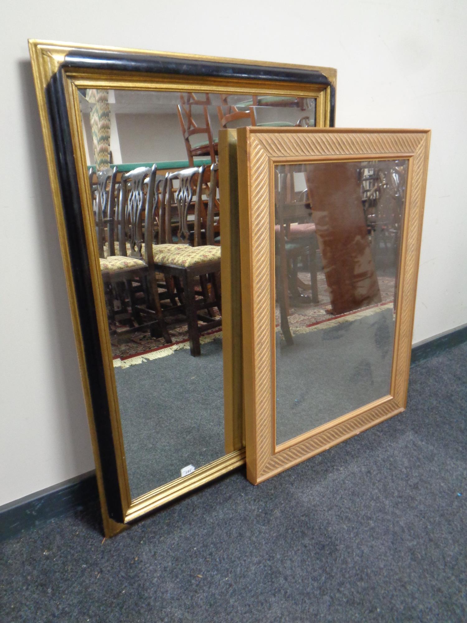 A contemporary gilt framed bevel edged mirror together with a further black and gilt framed bevel