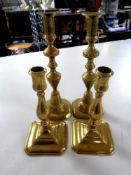 Two pairs of antique brass candlesticks