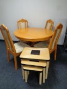 A circular pine pedestal kitchen table with four chairs,