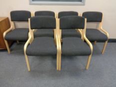 A set of six wood framed stacking chairs upholstered in a grey fabric