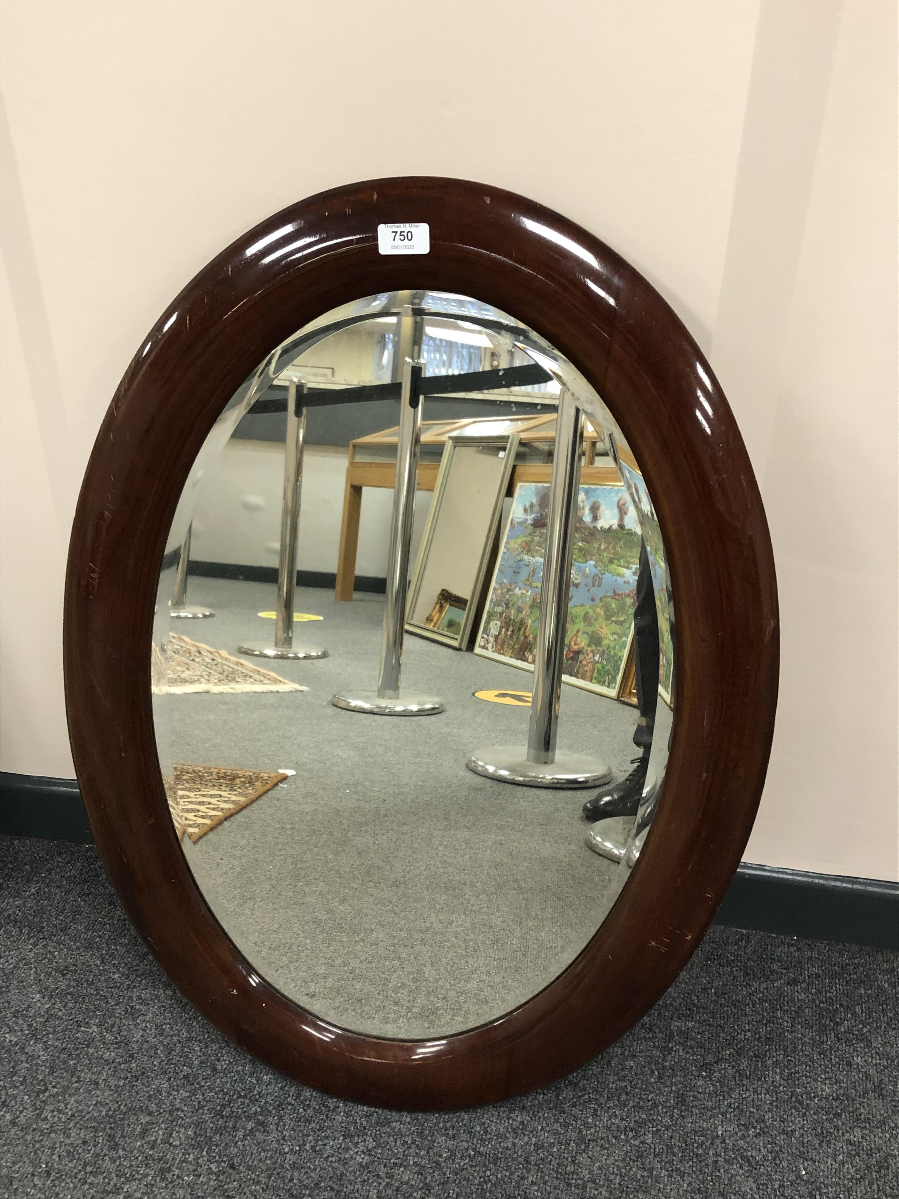 An early 20th century oval mirror,